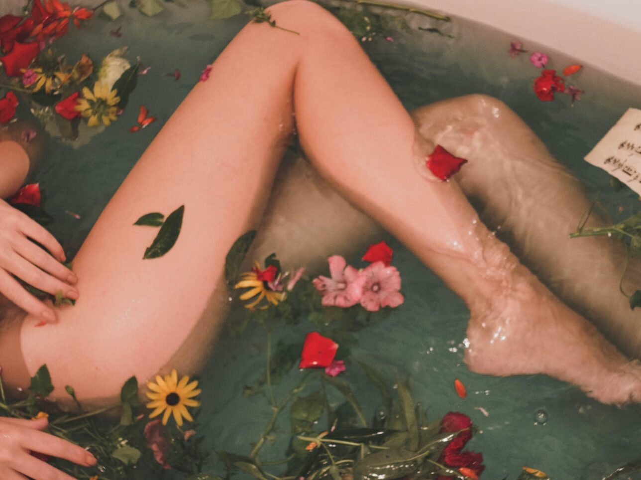 bathtub with water and flowers
