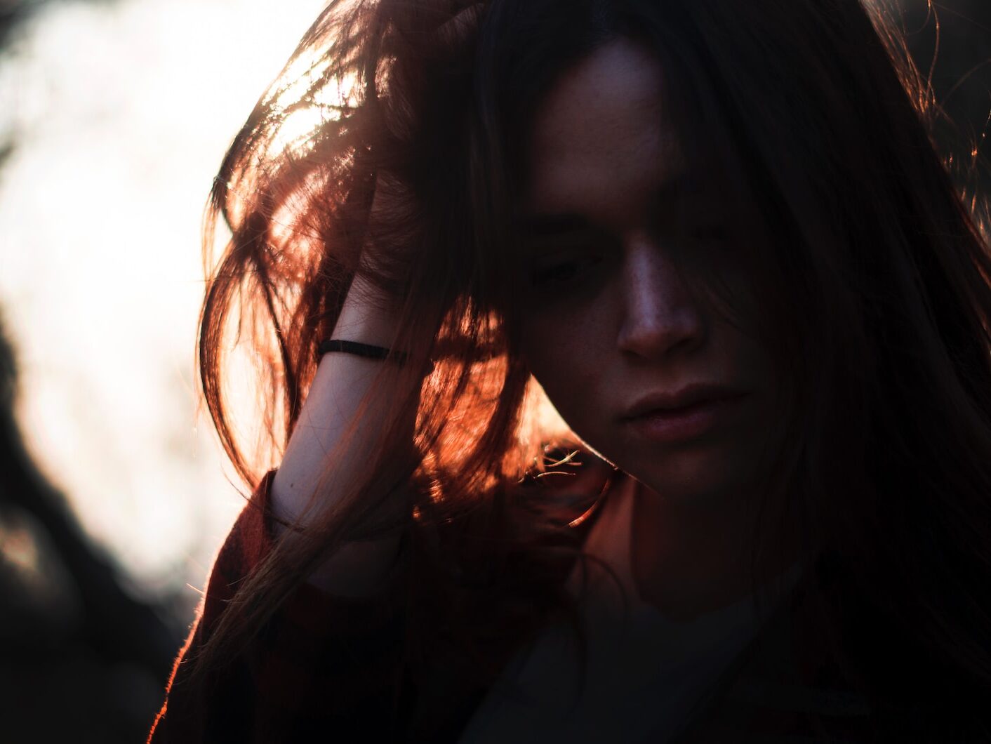 woman left hand on hair under sunset