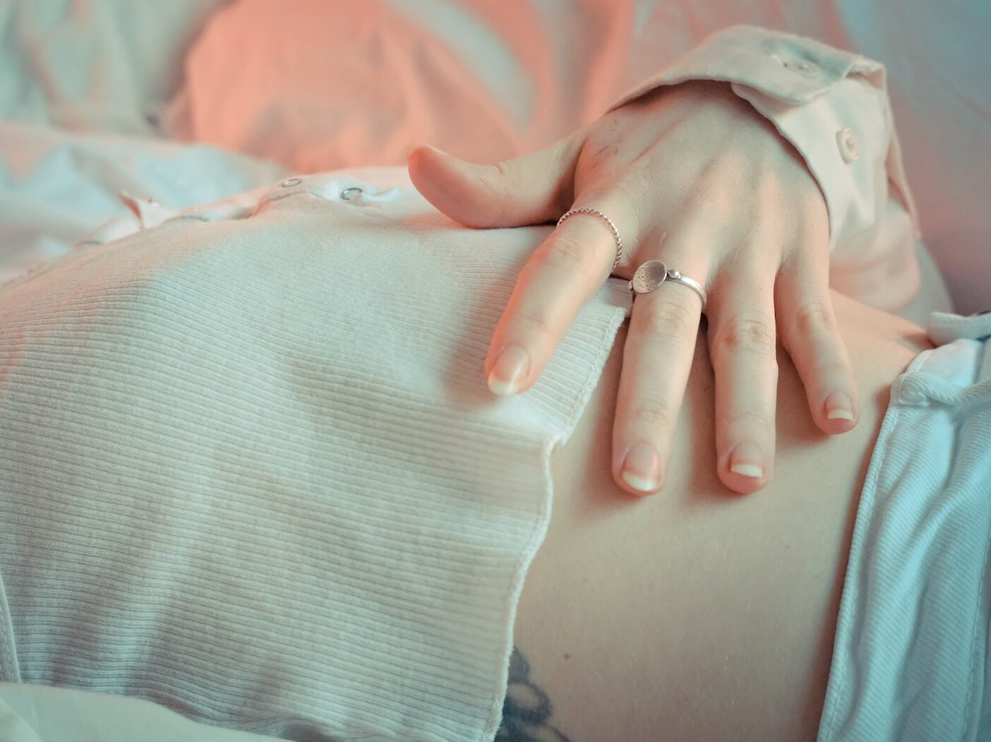 person wearing silver ring and silver ring