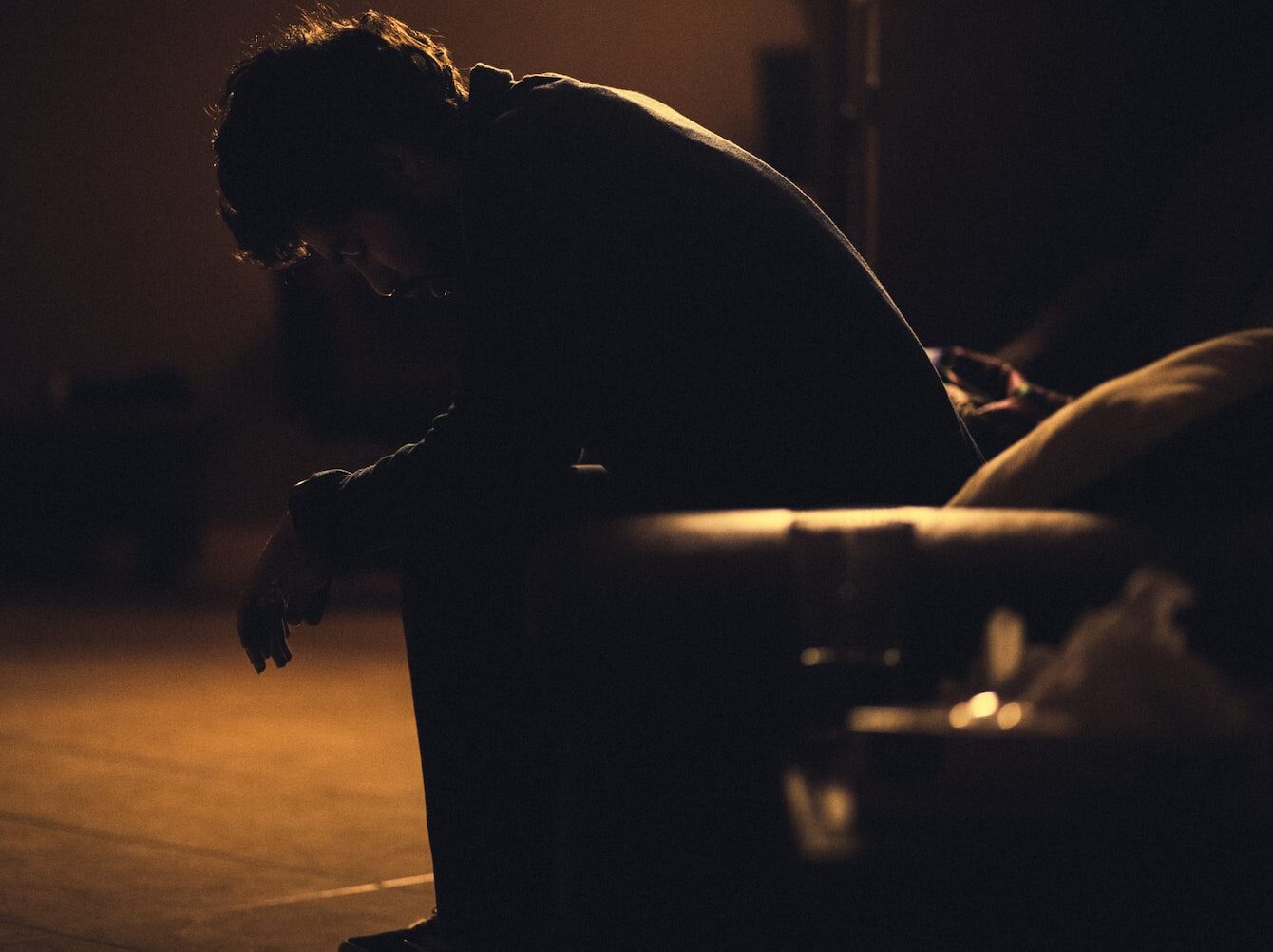 man in black shirt sitting on chair