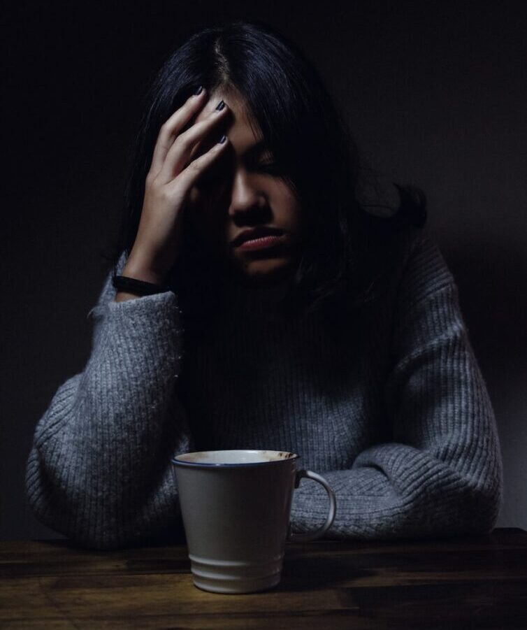 woman in gray sweater seating on chair