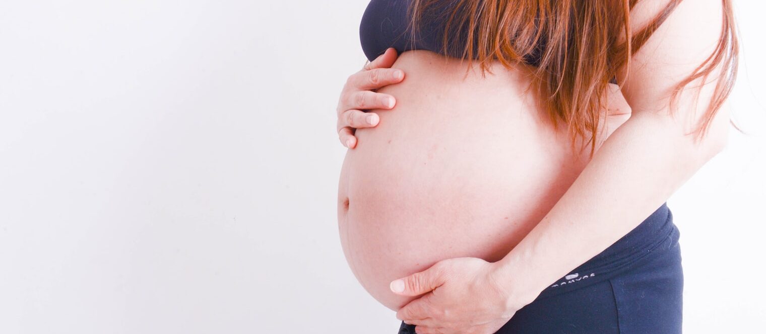 pregnant holding her tummy