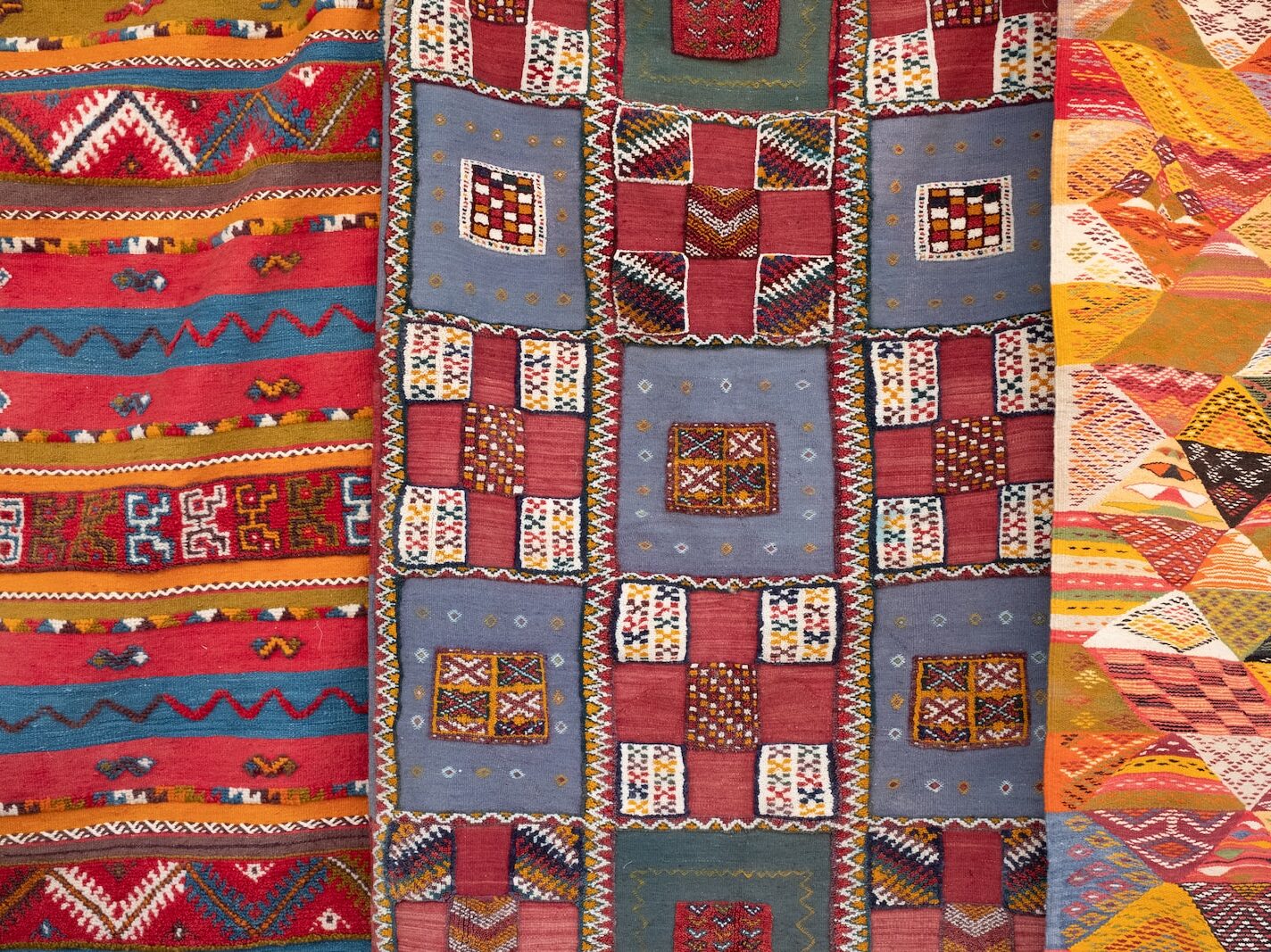 three assorted-color quilts