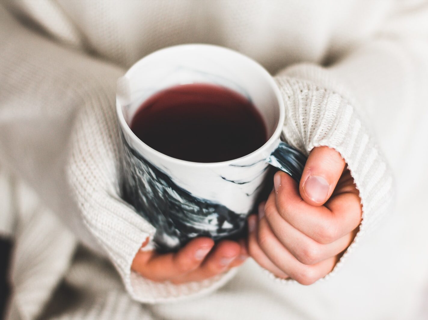 person holding cup of coffee