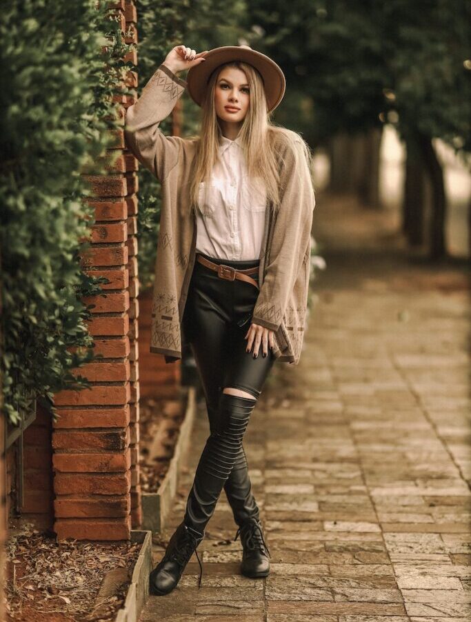 Woman Wearing Cardigan and Hat on City Street