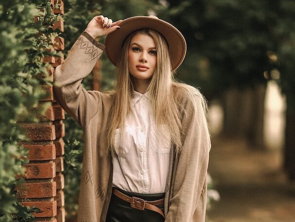 Woman Wearing Cardigan and Hat on City Street