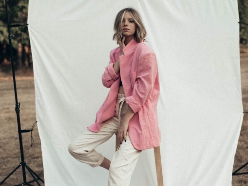 Stylish woman sitting on stool