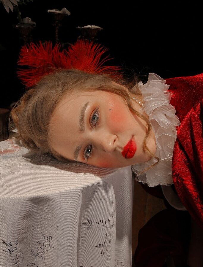 Model with red lips leaning on table