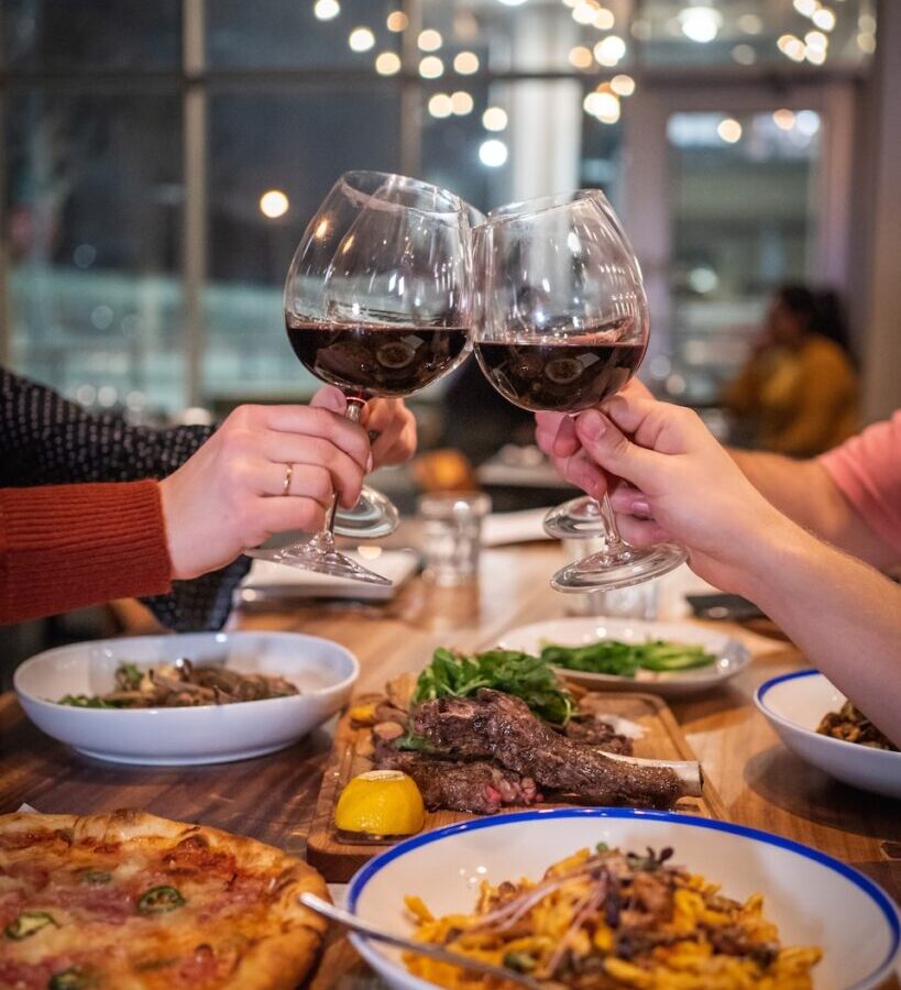 person holding clear wine glass