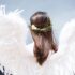 woman wearing white angel wings