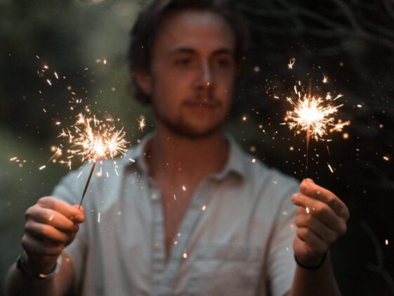 man holding sparklers
