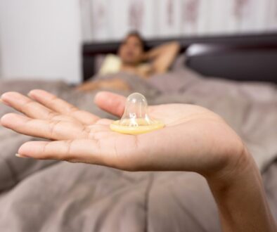 Close-up of Woman Holding Condom