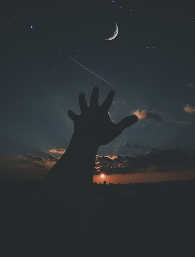 Person Hand and Crescent Moon