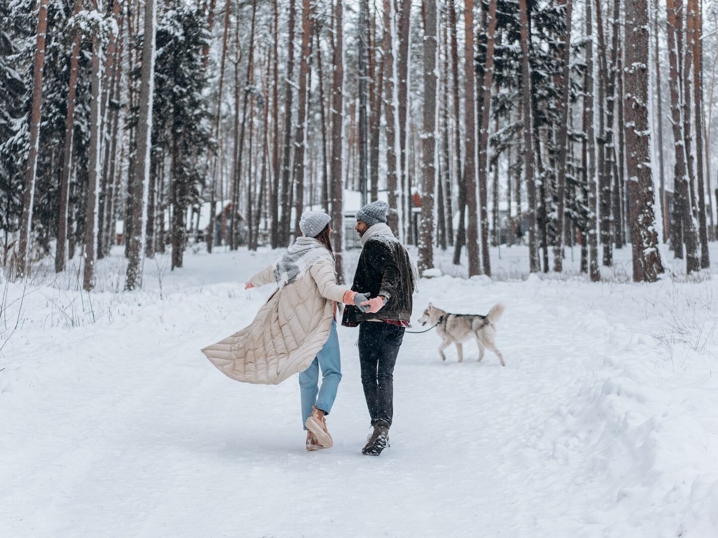 Back View of a Couple Walking on Snow Together