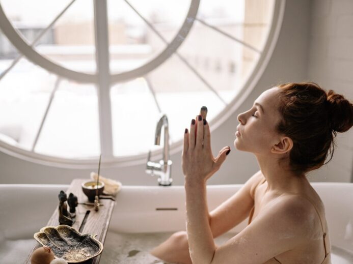 Woman Meditating on Bathtub