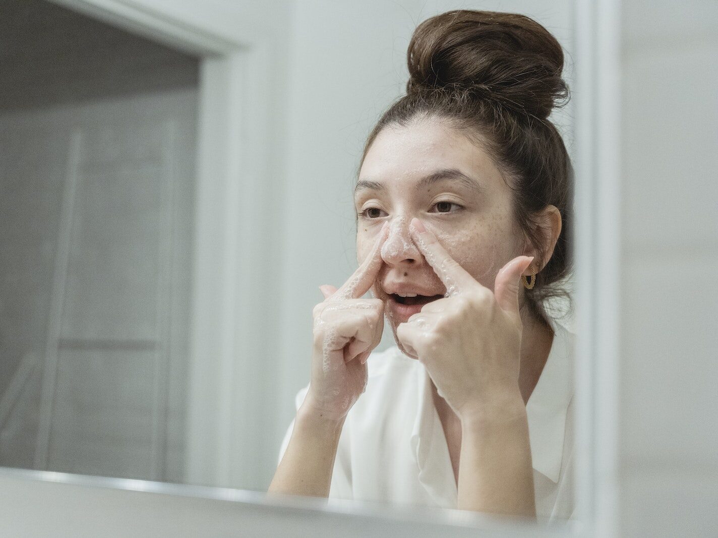 Young Woman Washing Her Face in the Bathroom