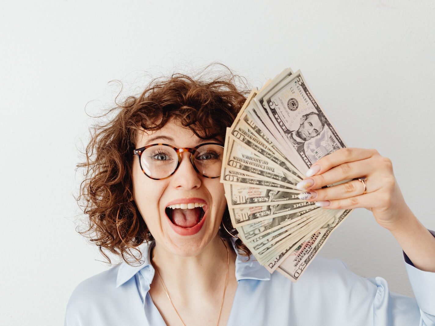 Happy Woman in Blue Long Sleeve Blouse Holding Money