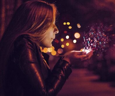 woman blowing sprinkle in her hand