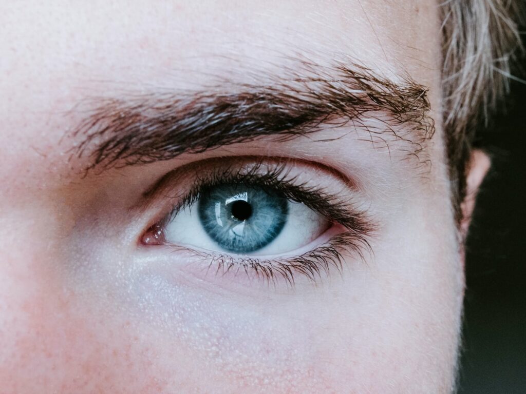 man's blue left eye