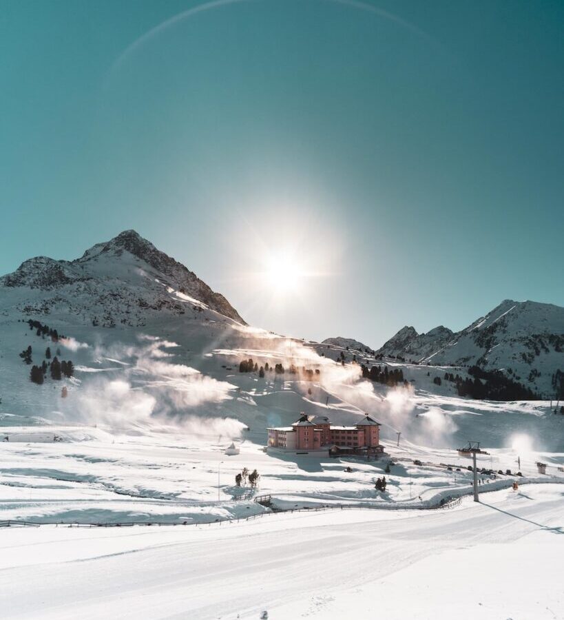 brown building on snow field during daytime
