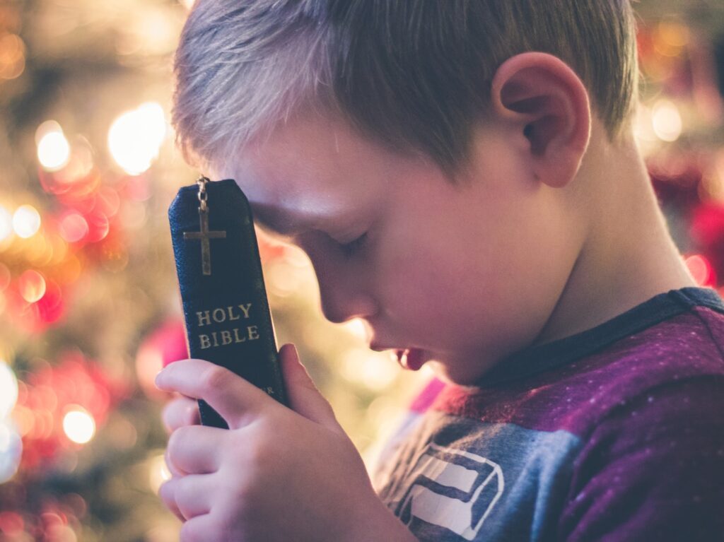 boy holding Holy Bible