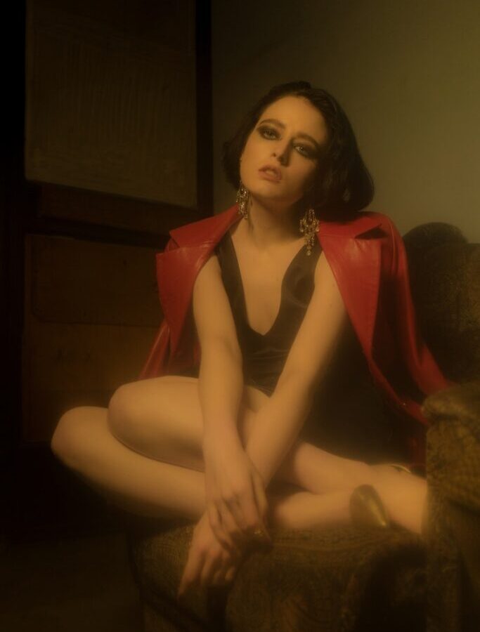 Gorgeous woman with smokey eyes in leather red jacker