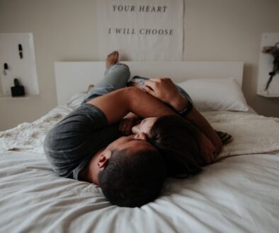 A man and woman cuddling together in bed.