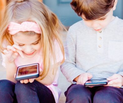 girl and boy using Android smartphones
