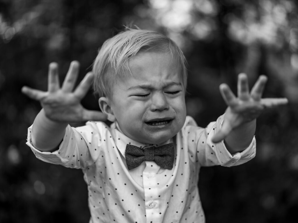 grayscale photo of girl in polka dot long sleeve shirt