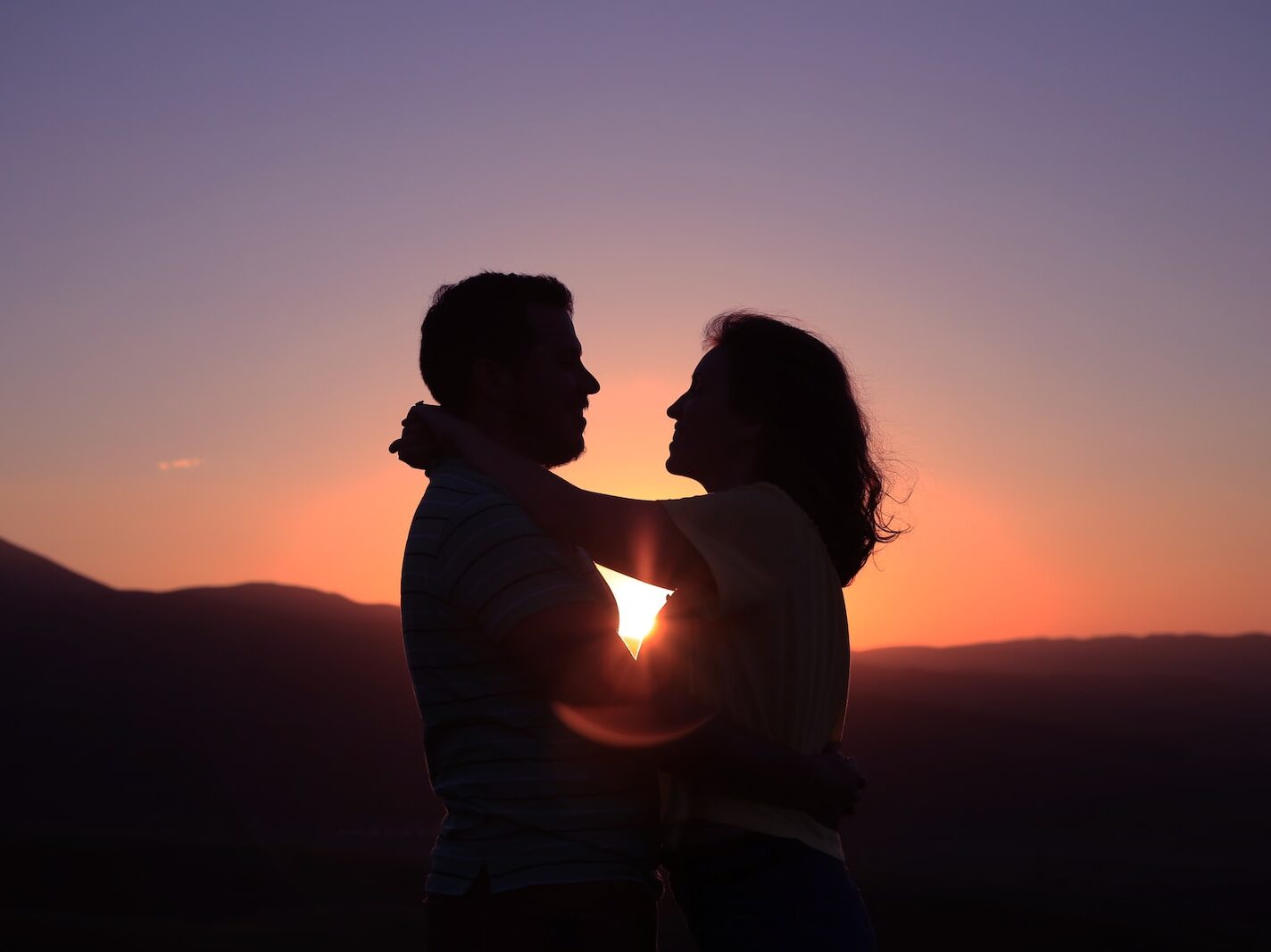 silhouette of hugging couple