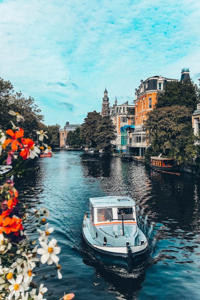 white boat on river near buildings during daytime