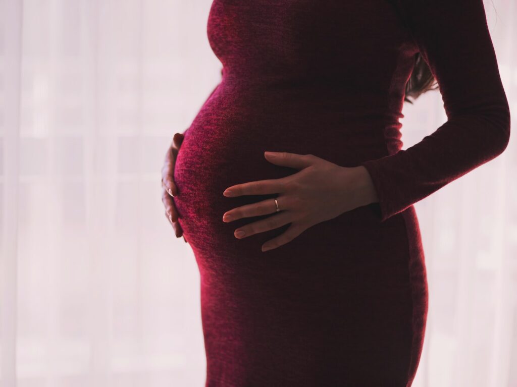 pregnant woman wearing red long-sleeved dress