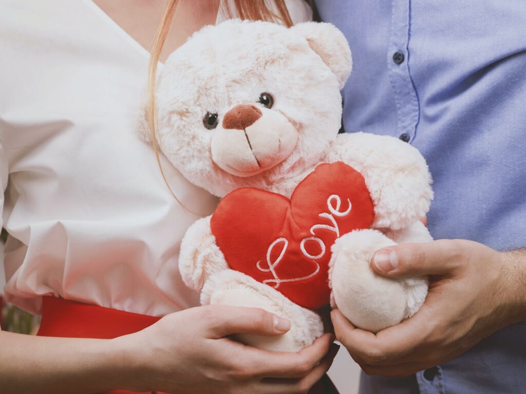 couple holding white bear plush toy