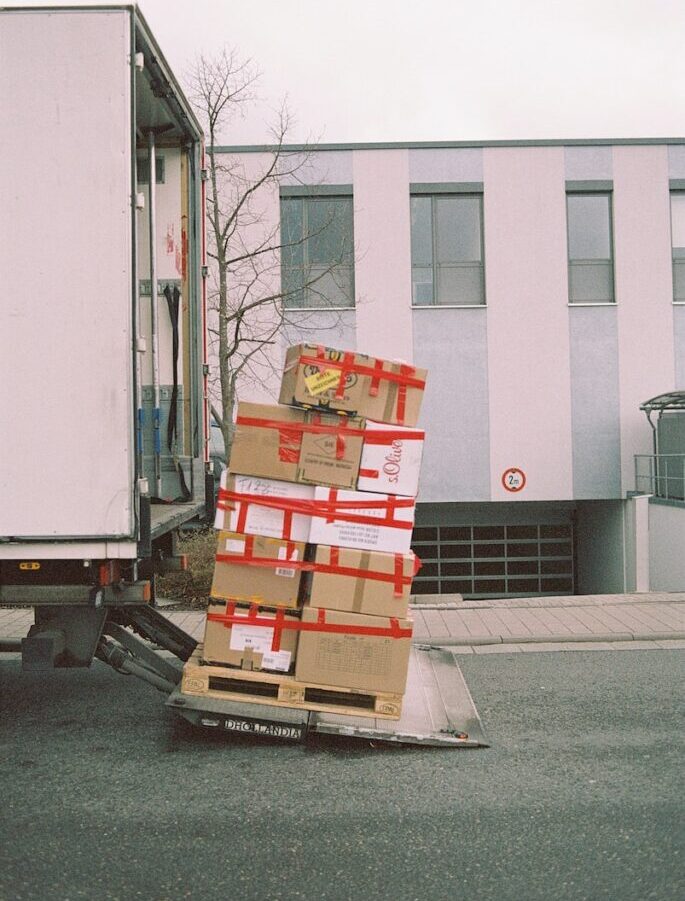 brown cardboard boxes on gray asphalt road