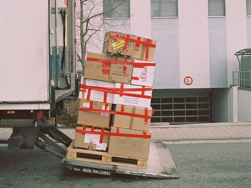 brown cardboard boxes on gray asphalt road