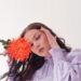 Dreamy woman with flower in studio