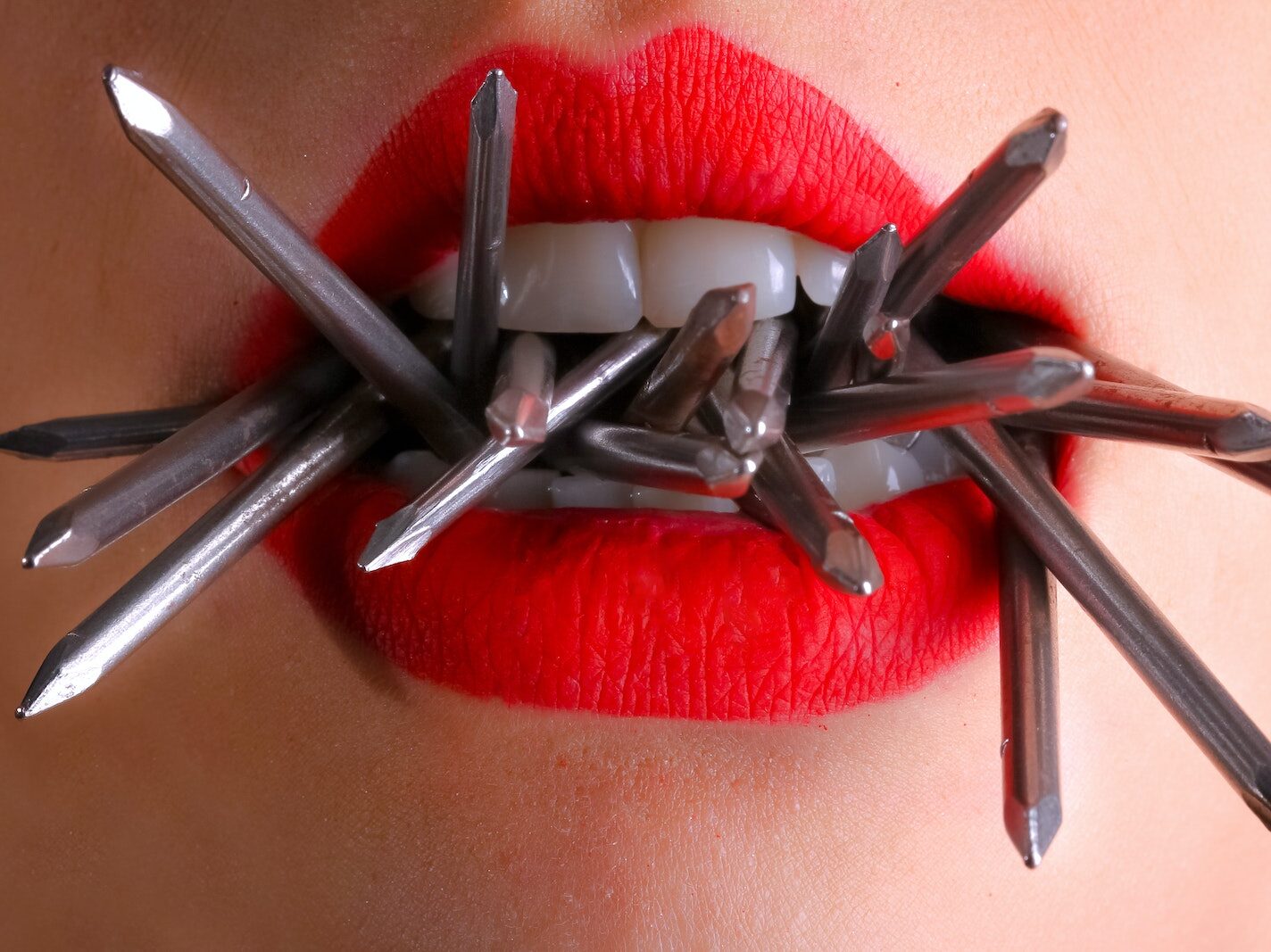 Woman Biting Gray Nails in Her Mouth