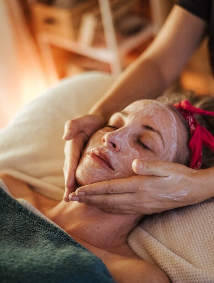 Female doing massage with mask on face
