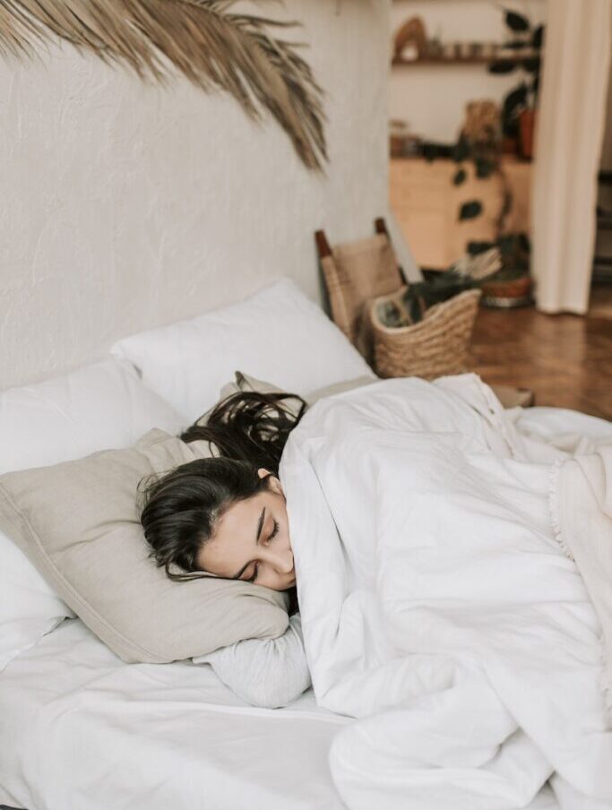 Woman Sleeping on a Bed With White Blanket