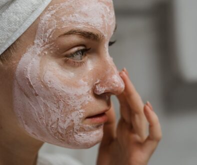 Close-up Photo of a Woman Applying Facial Cream