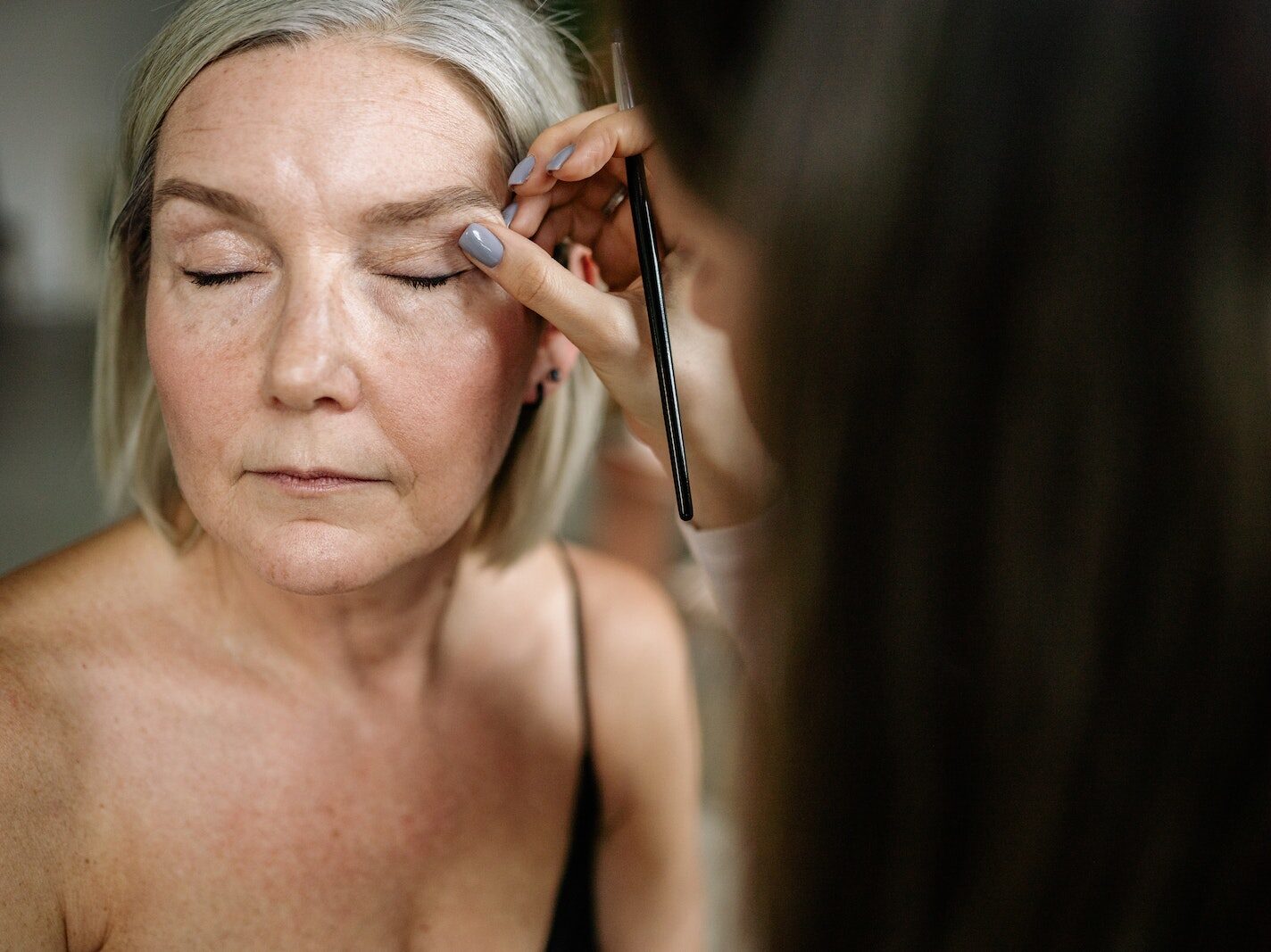 An Elderly Woman Having Her Makeup Done