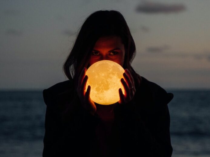woman holding moon lamp