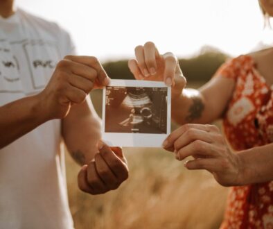 person holding a photo of a man and woman