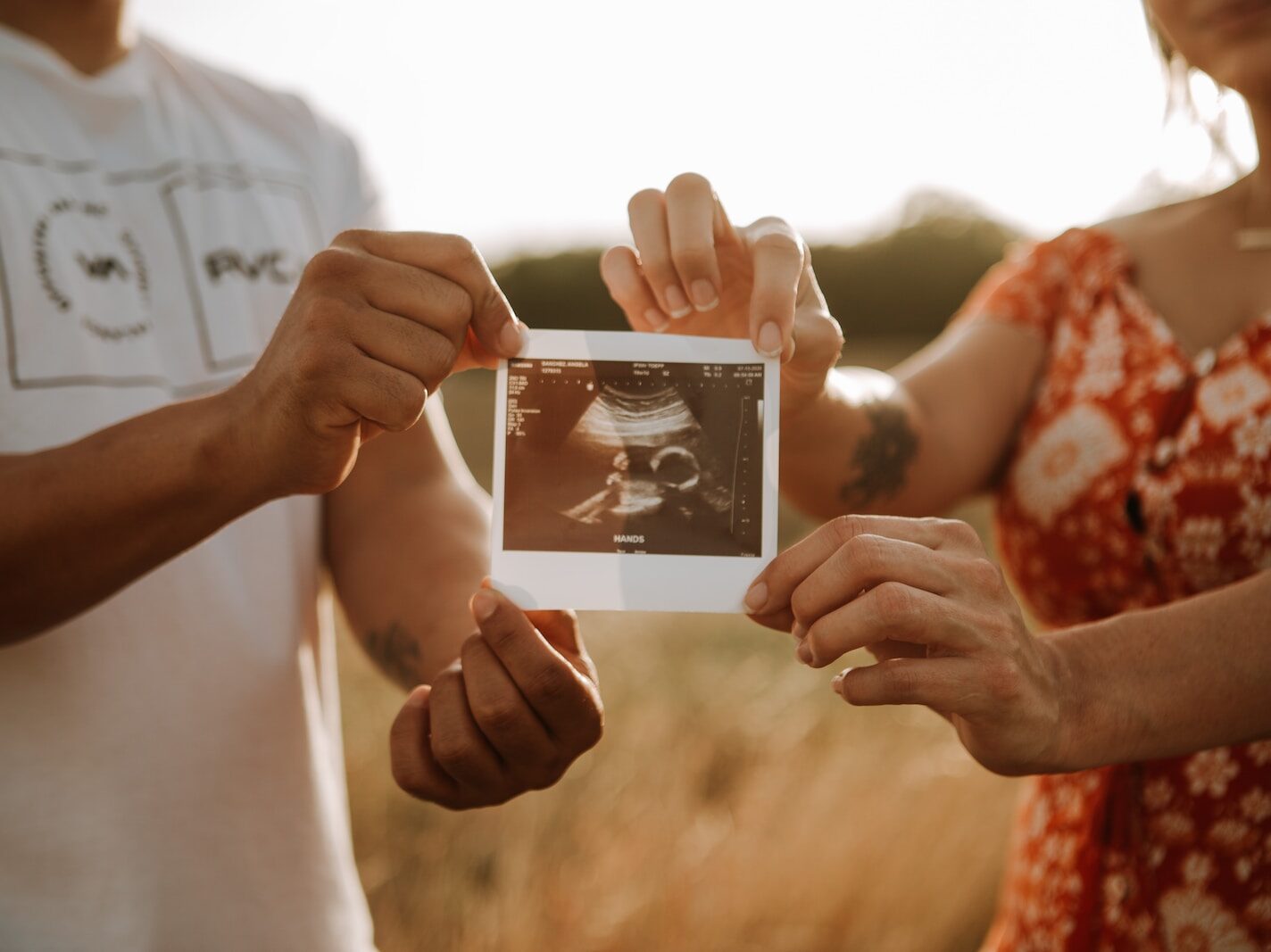 person holding a photo of a man and woman