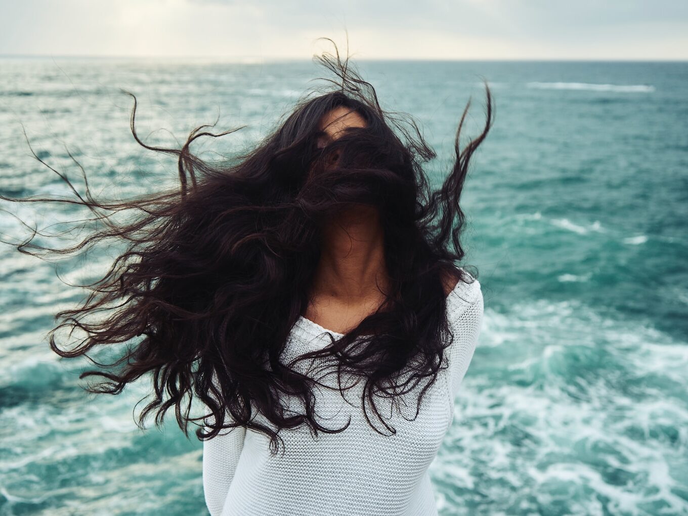 woman standing near body of water during daytime