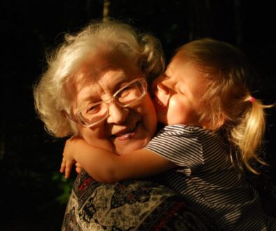 woman in black and white striped shirt hugging girl in black and white striped shirt