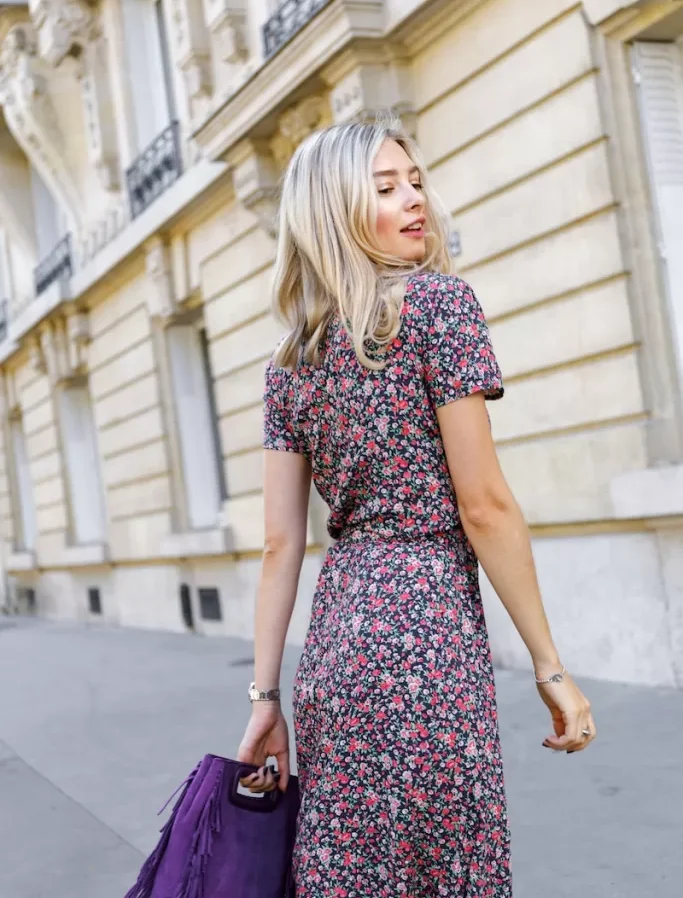 a woman in a dress is walking down the street
