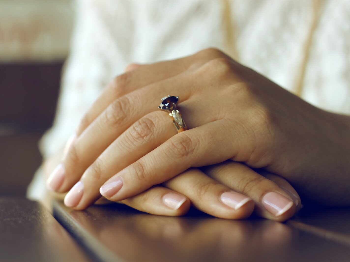 person wearing silver-colored ring with black gemstone