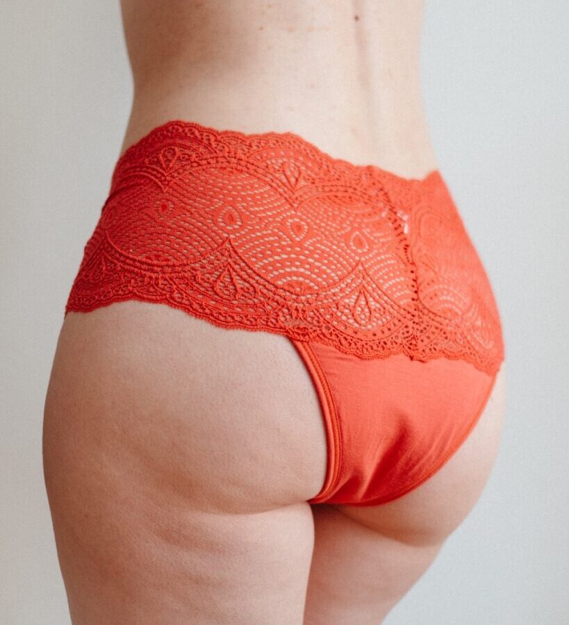 a woman's butt with a lacy orange panties