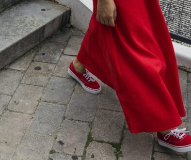 Close-up of Woman Walking on a Sidewalk in All Red Outfit